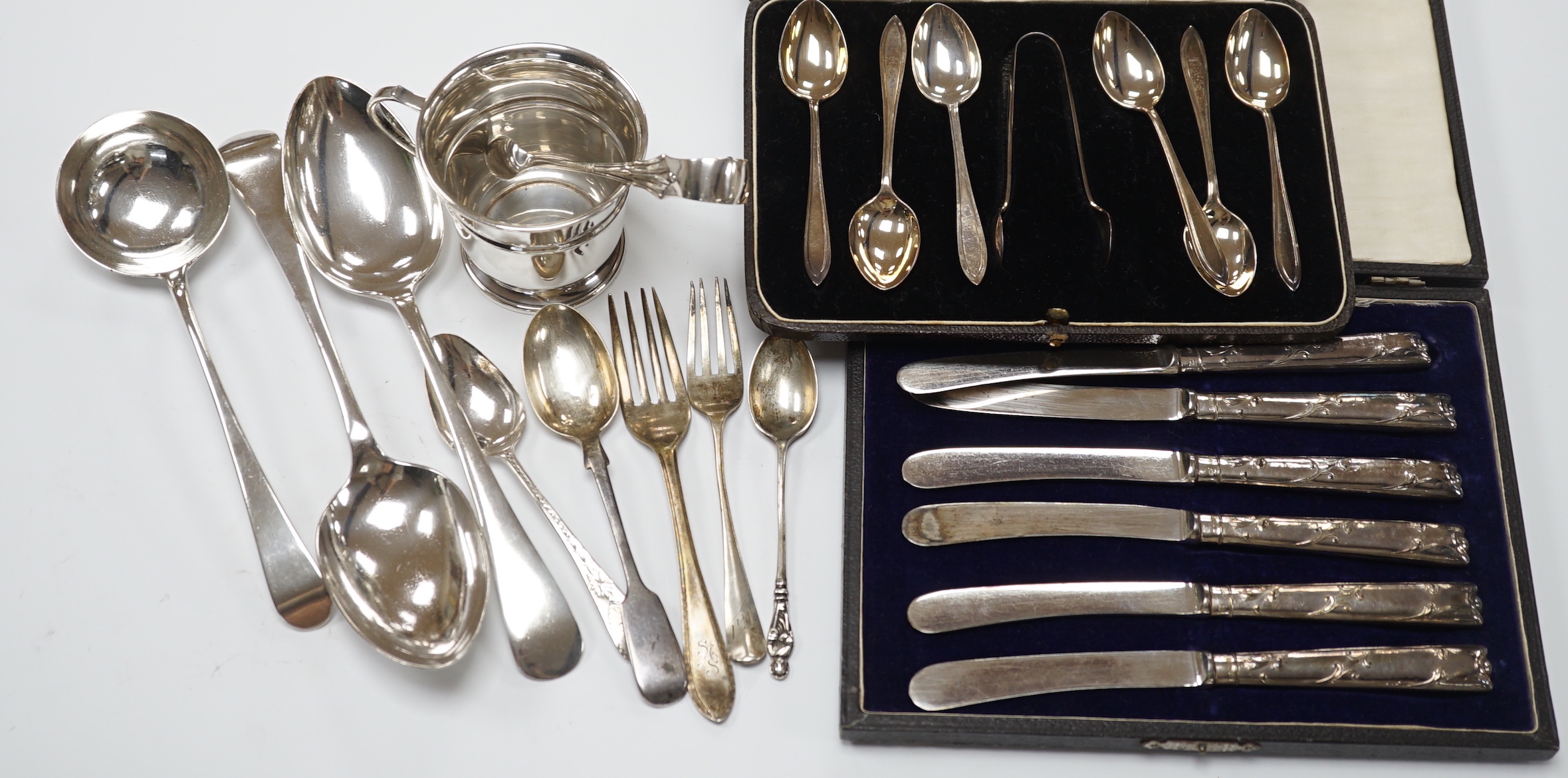 Two cased sets of silver flatware including teaspoons with tongs, nine assorted items of silver flatware including an 18th century base mark sauce ladle and a pair of later tablespoons and a small silver christening mug.